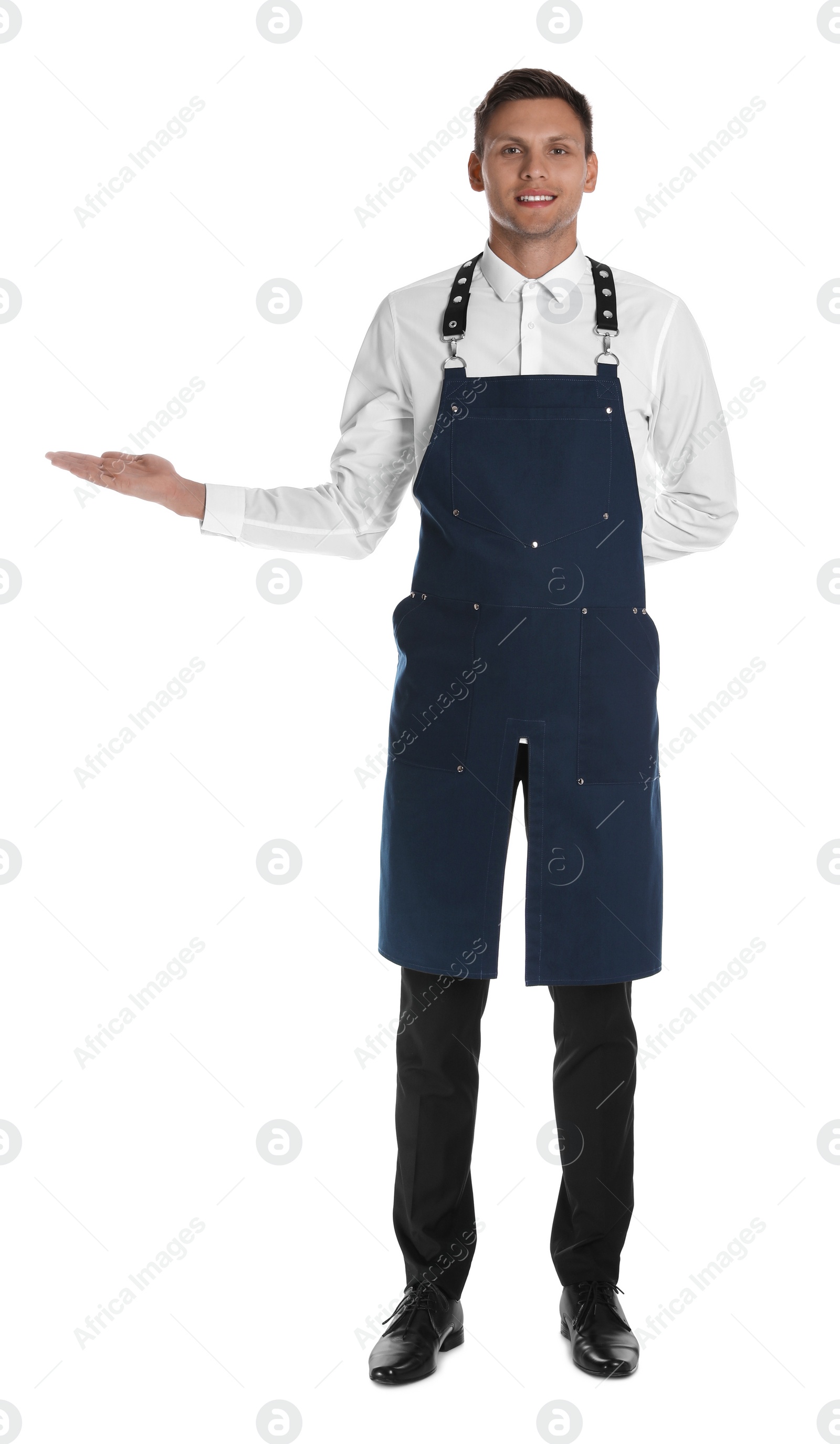 Photo of Full length portrait of happy young waiter in uniform on white background