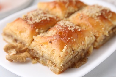 Eastern sweets. Pieces of tasty baklava on white table, closeup