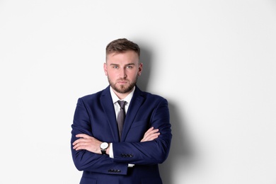 Portrait of serious man in office suit on white background