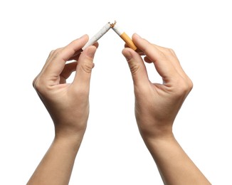 Photo of Stop smoking. Man holding broken cigarette on white background, closeup