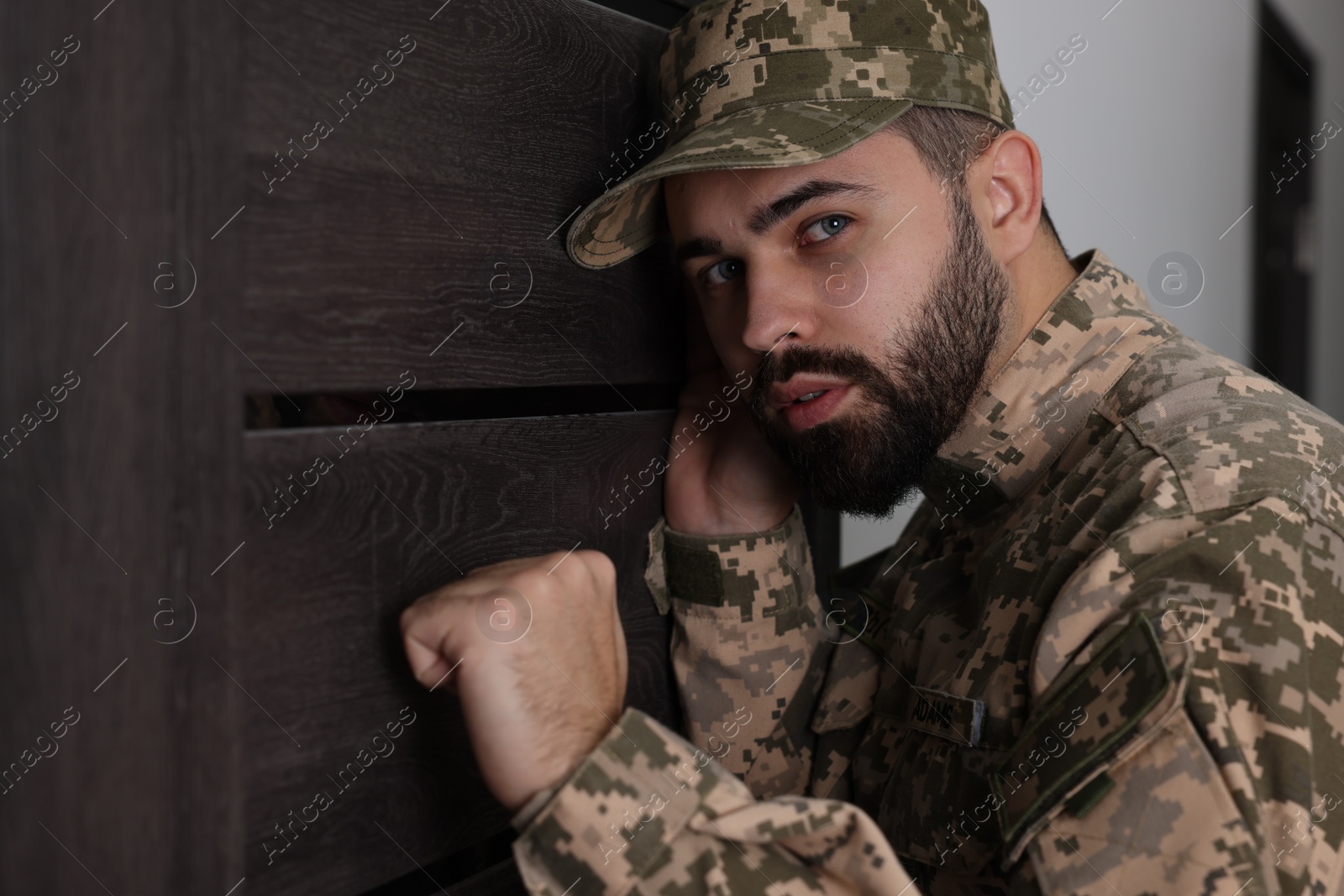 Photo of Military commissariat representative knocking on wooden door