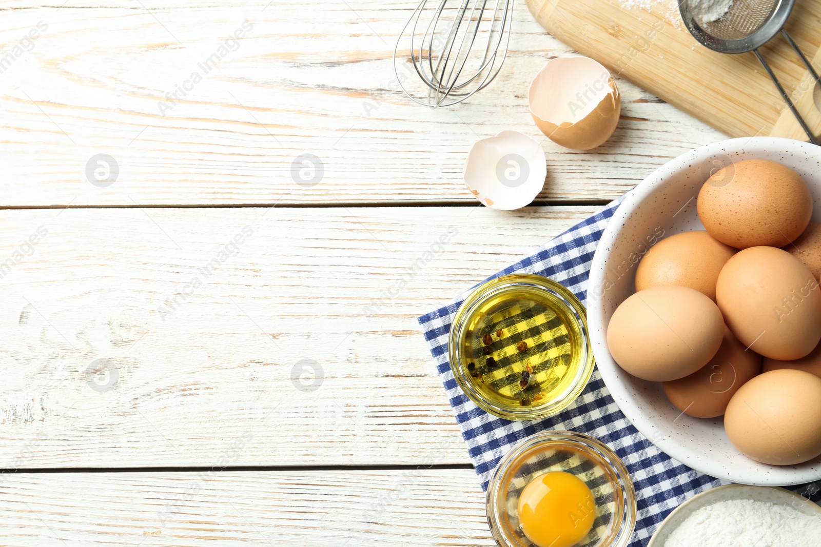 Photo of Flat lay composition with chicken eggs on white wooden table. Space for text