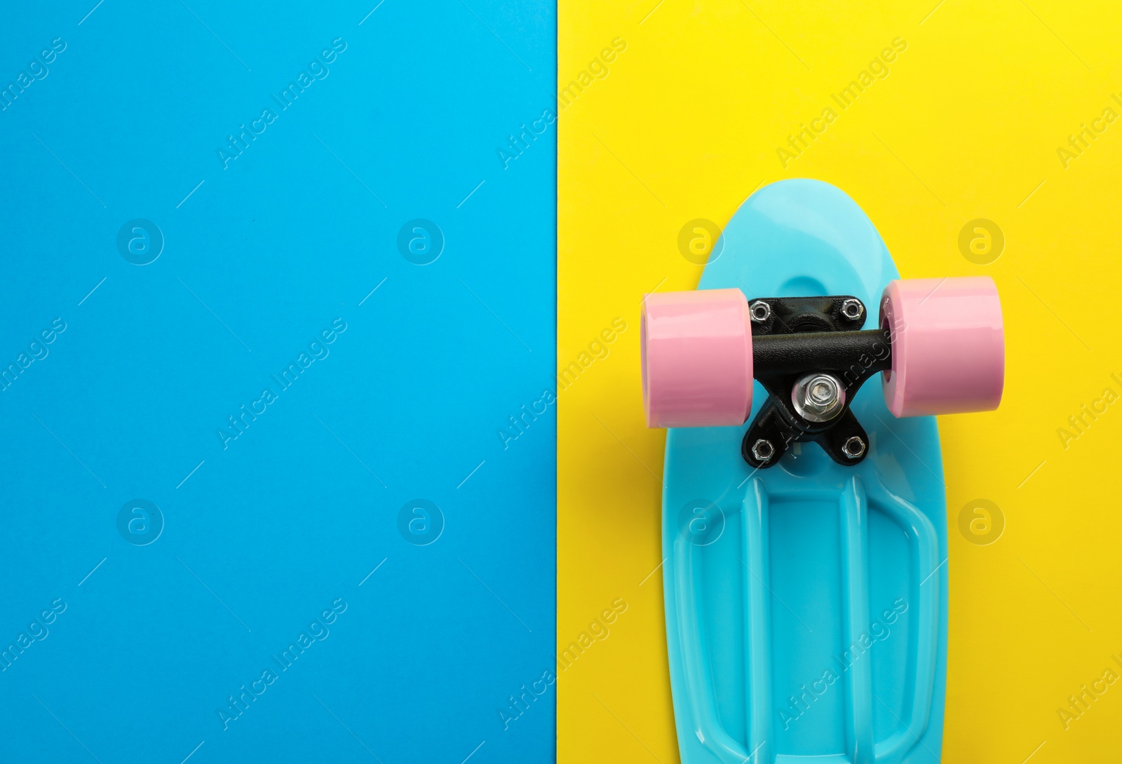 Photo of Turquoise skateboard on color background, top view. Space for text