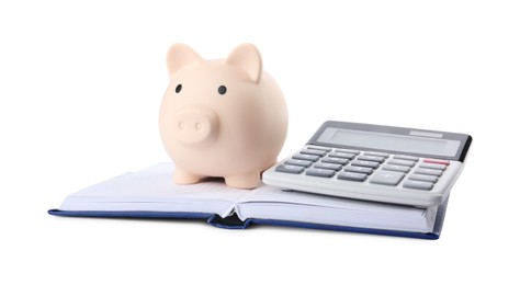 Calculator, piggy bank and notebook isolated on white