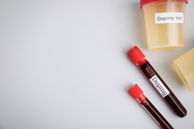 Jars, test tubes with samples on light grey background, flat lay and space for text. Doping control