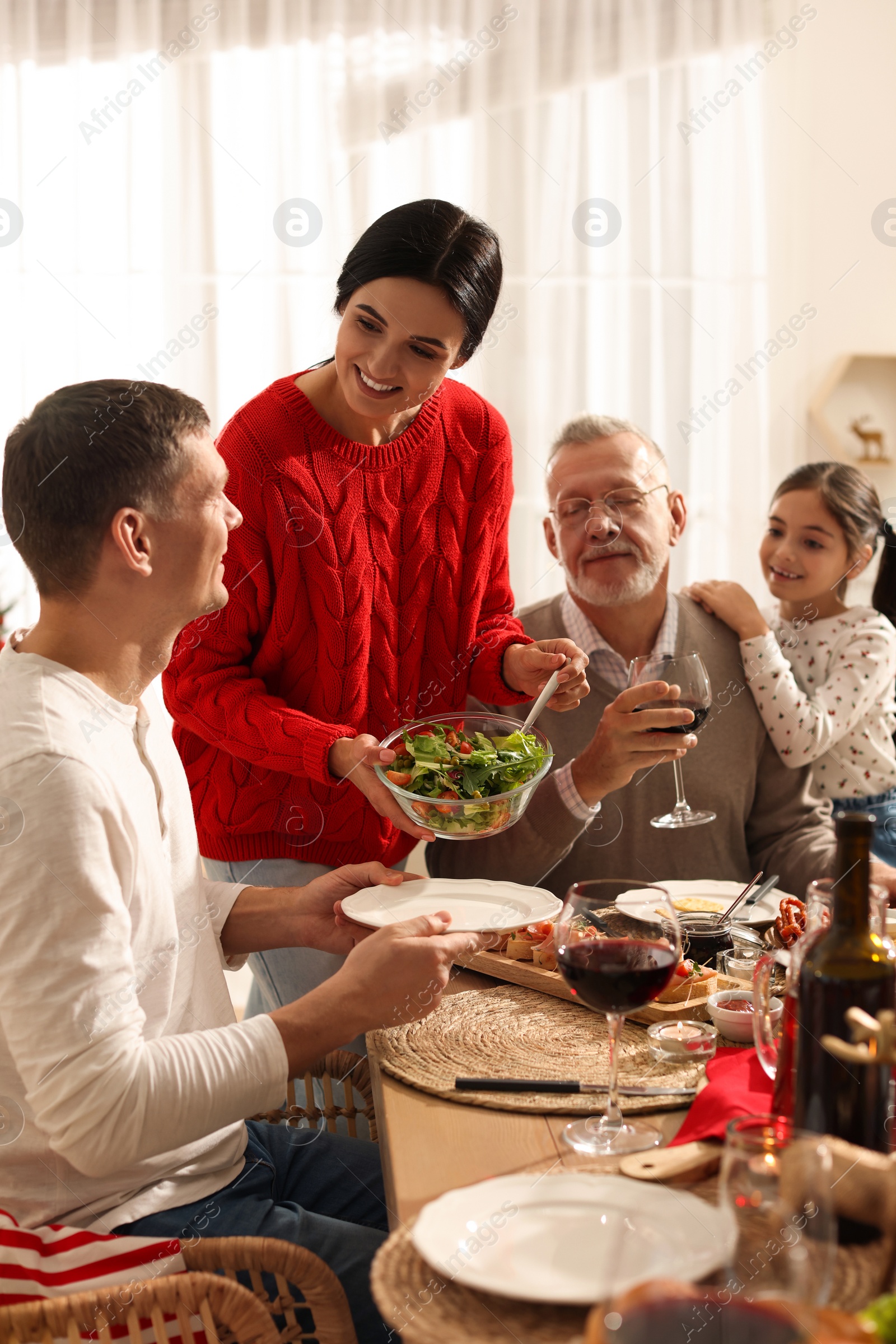 Photo of Happy family enjoying festive dinner at home. Christmas celebration