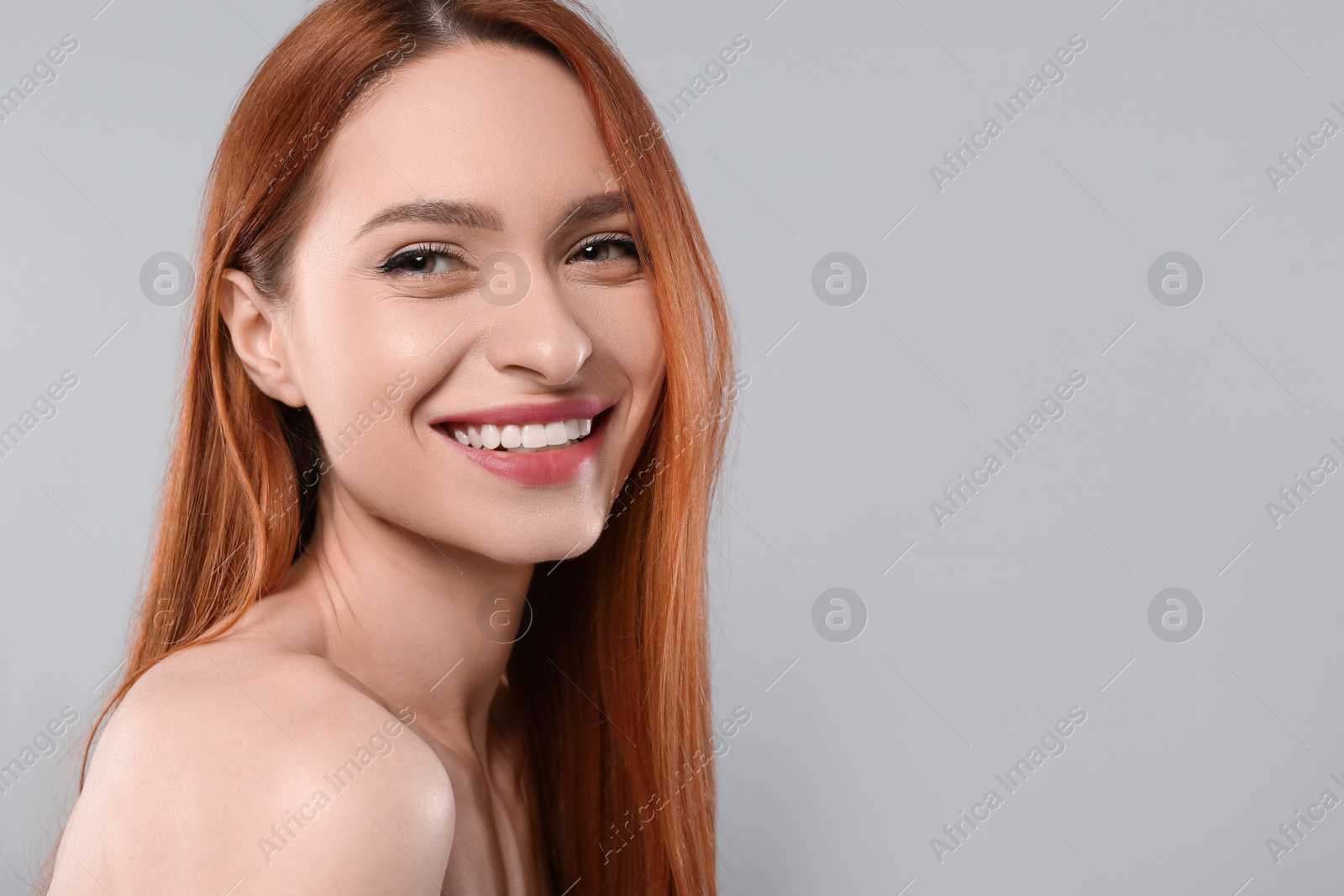 Photo of Portrait of beautiful young woman on light gray background, space for text