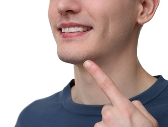 Young man showing his teeth with whitening strip on light background, closeup. Space for text