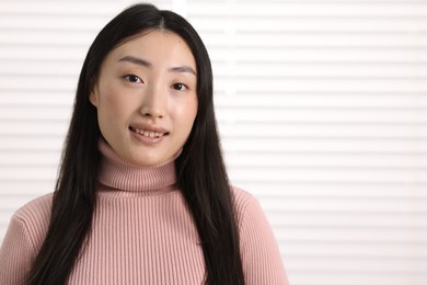 Portrait of smiling businesswoman in office. Space for text