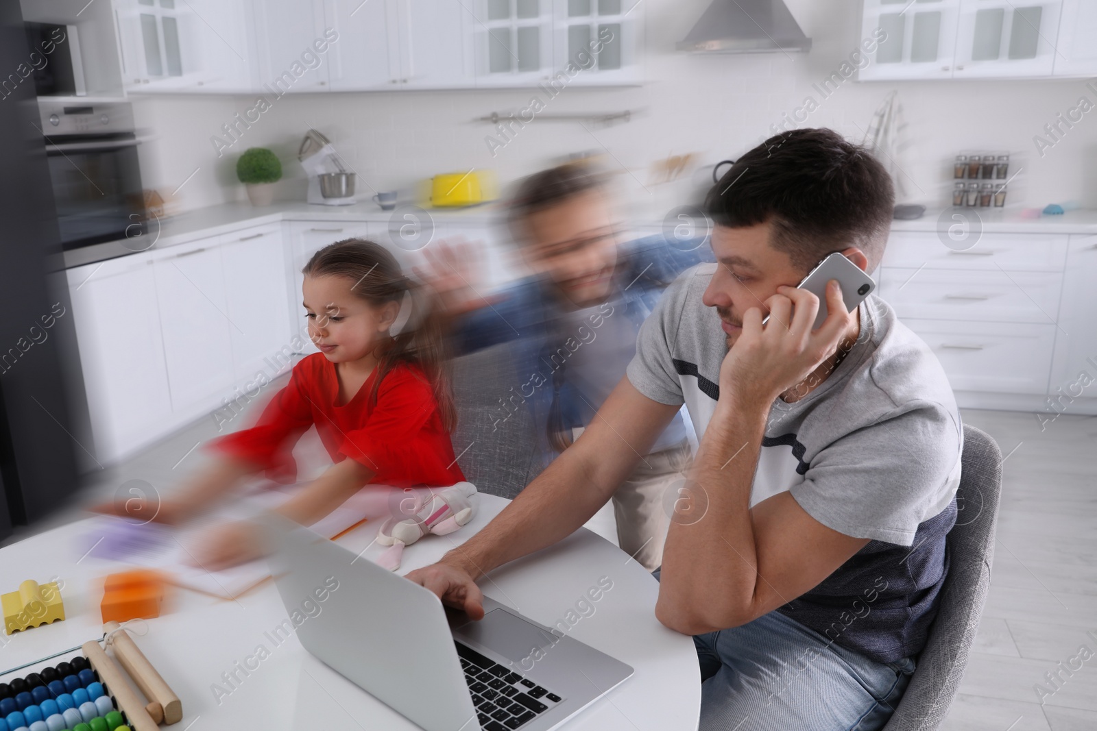 Image of Children disturbing overwhelmed man in kitchen. Working from home during quarantine