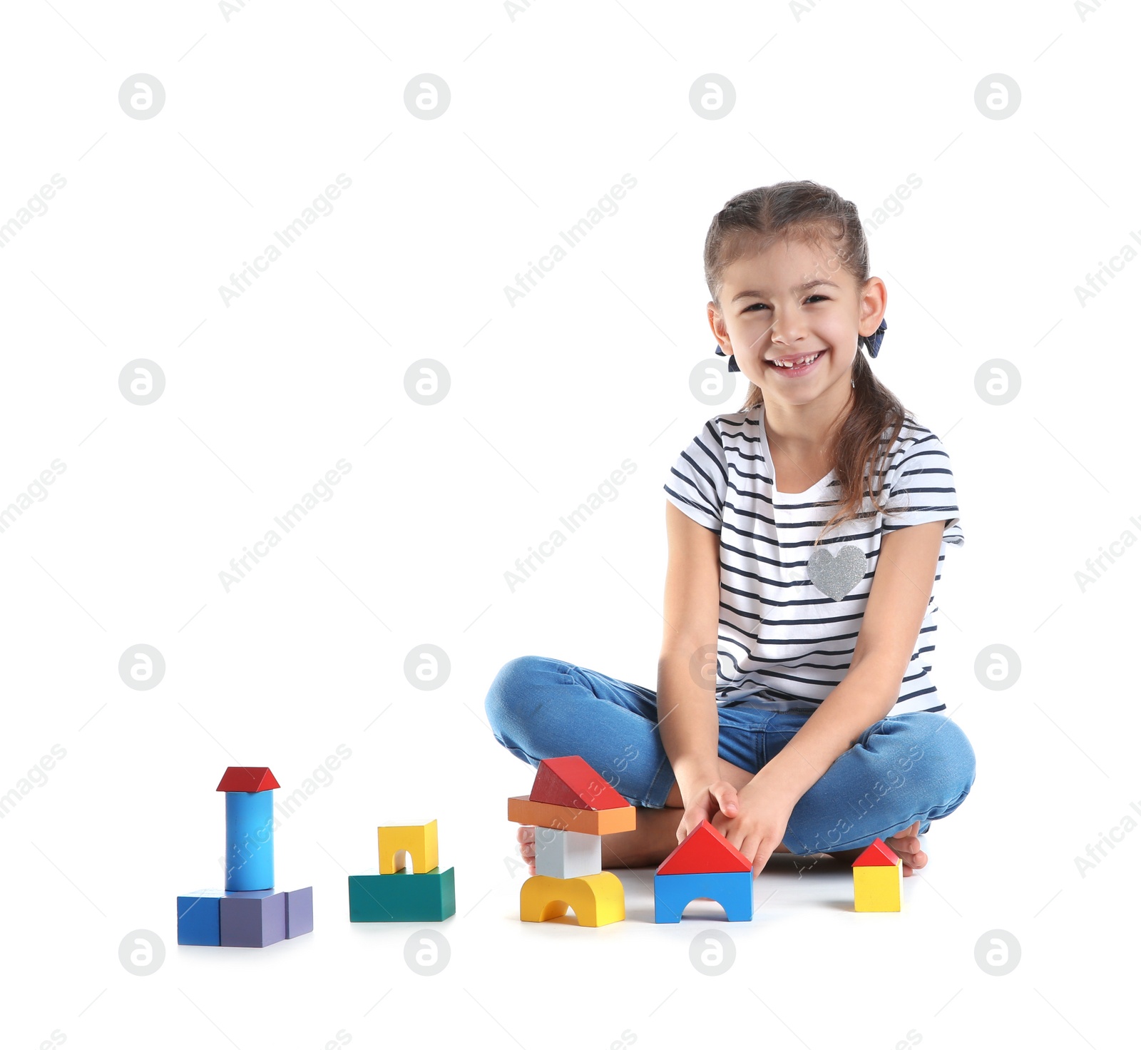 Photo of Cute child playing with colorful blocks on white background