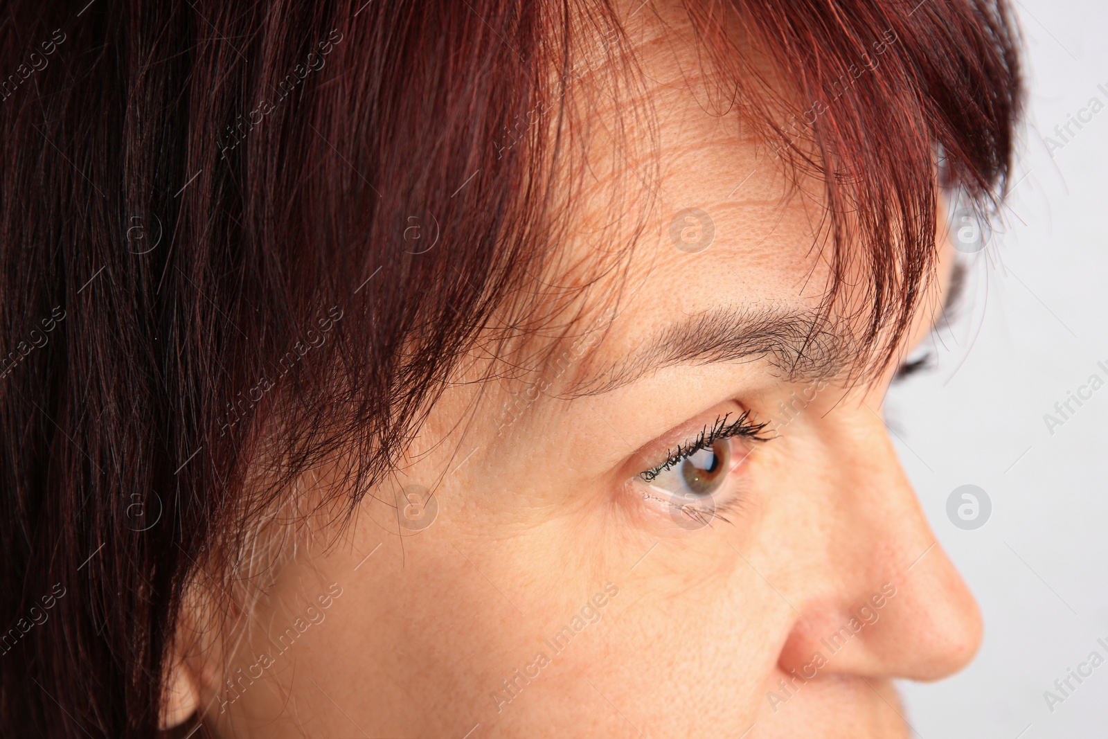 Photo of Closeup view of older woman on white background