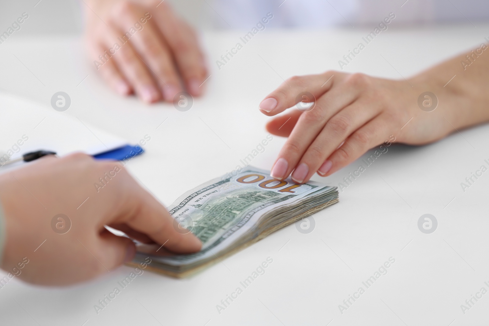 Photo of Patient giving bribe to doctor in clinic, closeup. Corrupted medicine