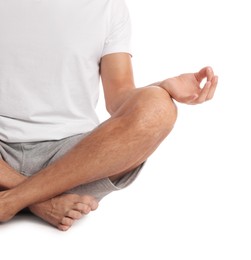 Man meditating on white background, closeup. Harmony and zen