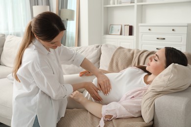 Photo of Doula taking care of pregnant woman at home. Preparation for child birth