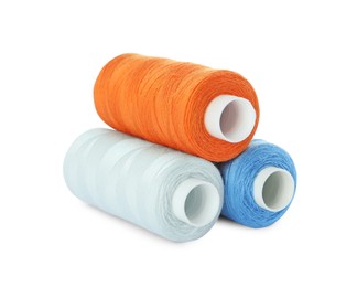 Different colorful sewing threads on white background