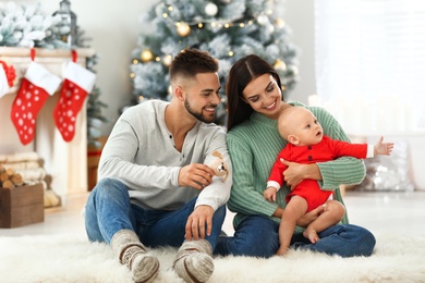 Happy family with cute baby at home. Christmas celebration