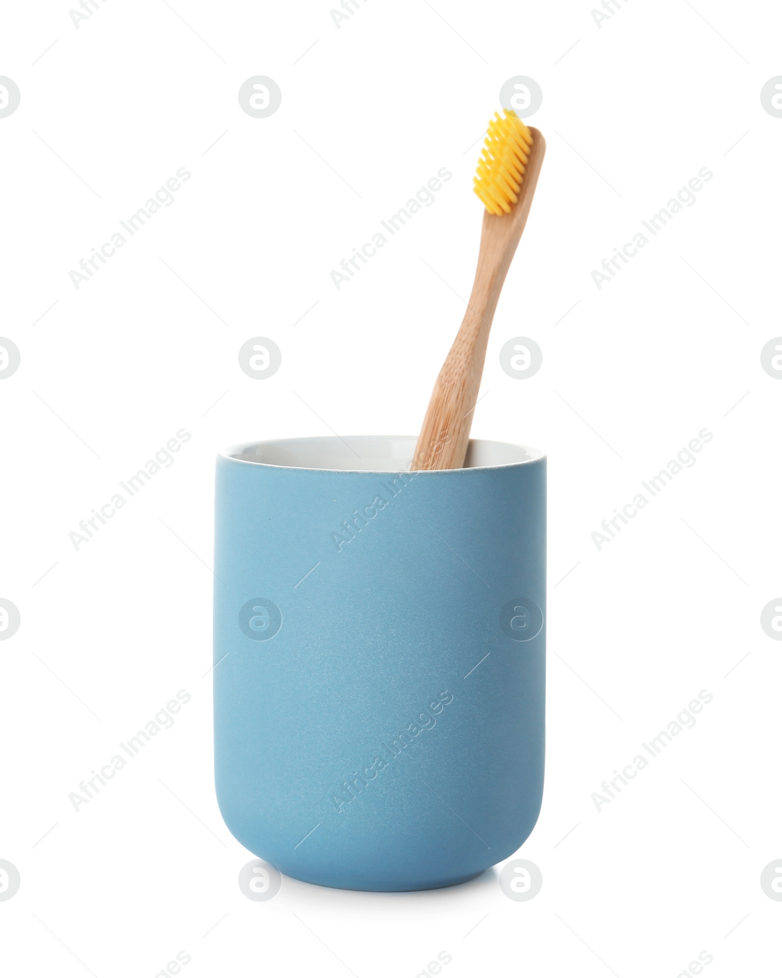 Photo of Bamboo toothbrush in holder on white background. Dental care