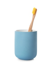 Bamboo toothbrush in holder on white background. Dental care