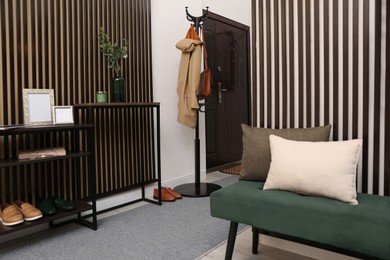 Modern hallway interior with console table and clothes rack