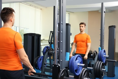 Young man having heart attack in gym