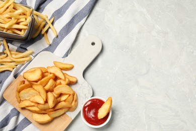 Photo of Different snacks and tasty ketchup on light gray table, flat lay. Space for text