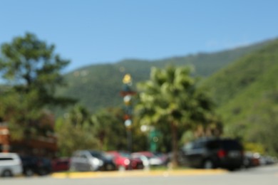 Photo of Blurred view of mountains, palm trees and city road