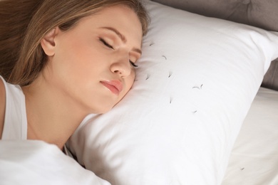 Photo of Young woman with eyelash loss problem sleeping in bed. Space for text