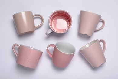 Photo of Pink cups on white background, flat lay