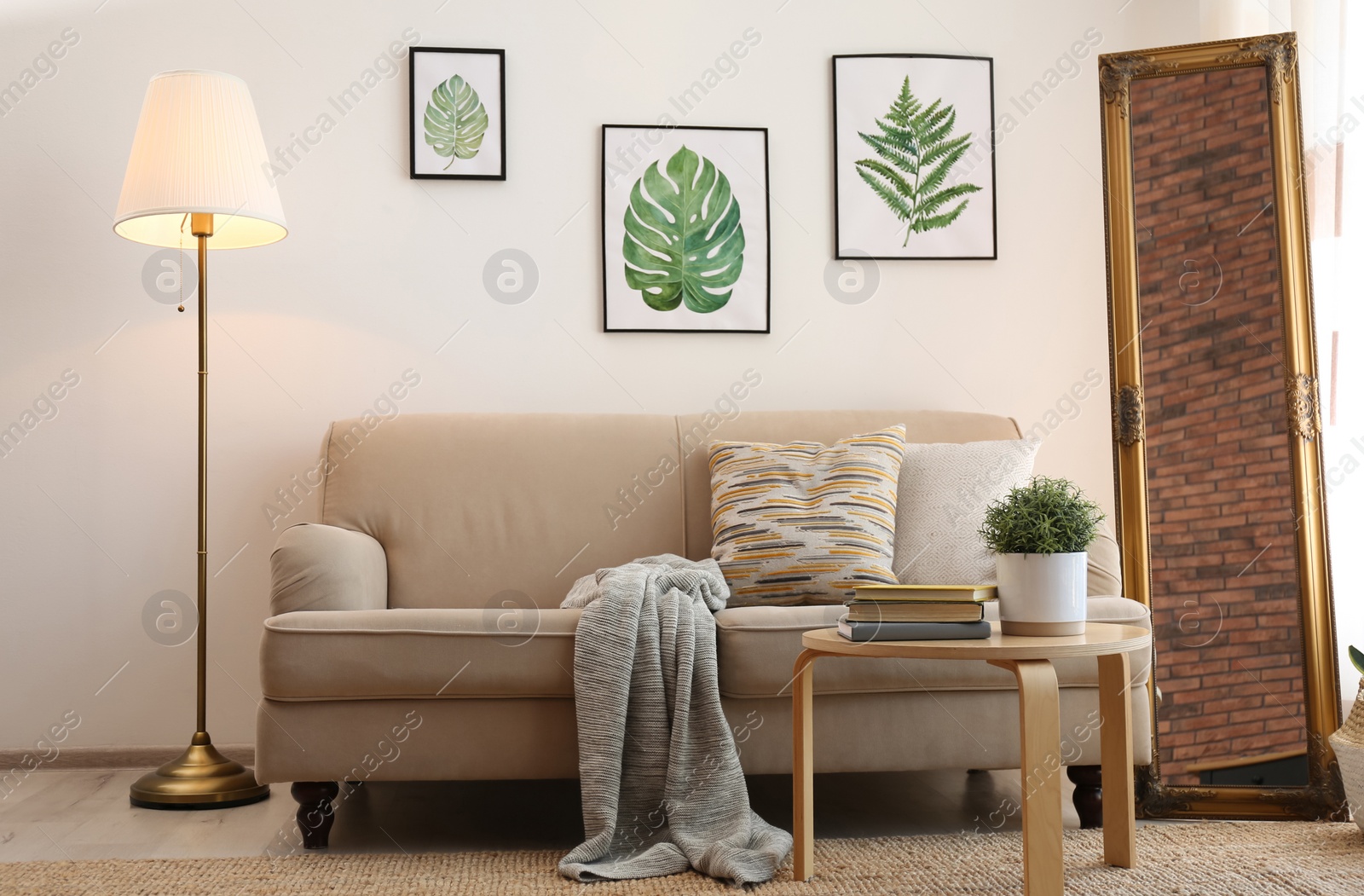 Photo of Elegant mirror near sofa in stylish living room interior