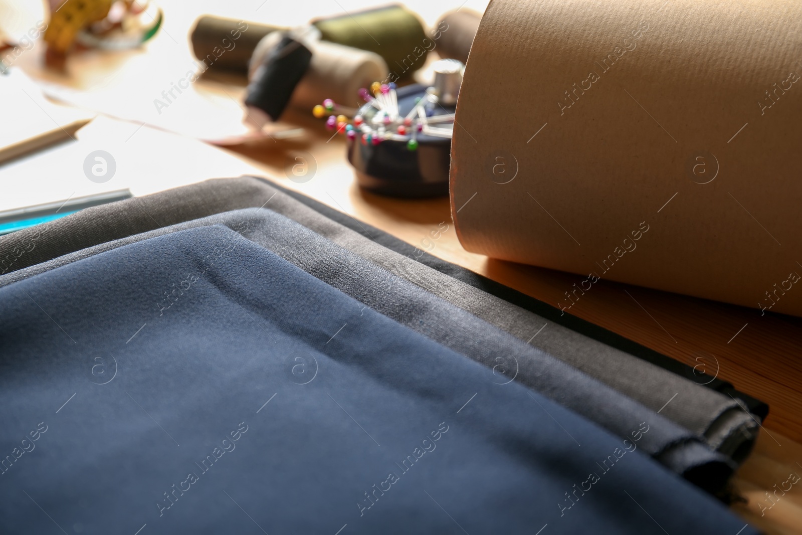 Photo of Fabrics and accessories for tailoring on table