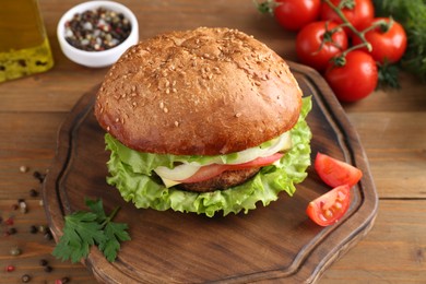 Photo of Delicious vegetarian burger served on wooden table