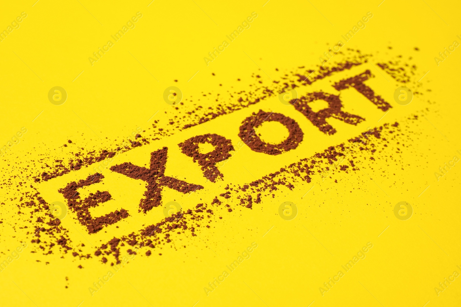 Photo of Word Export made of cacao powder on yellow background, closeup