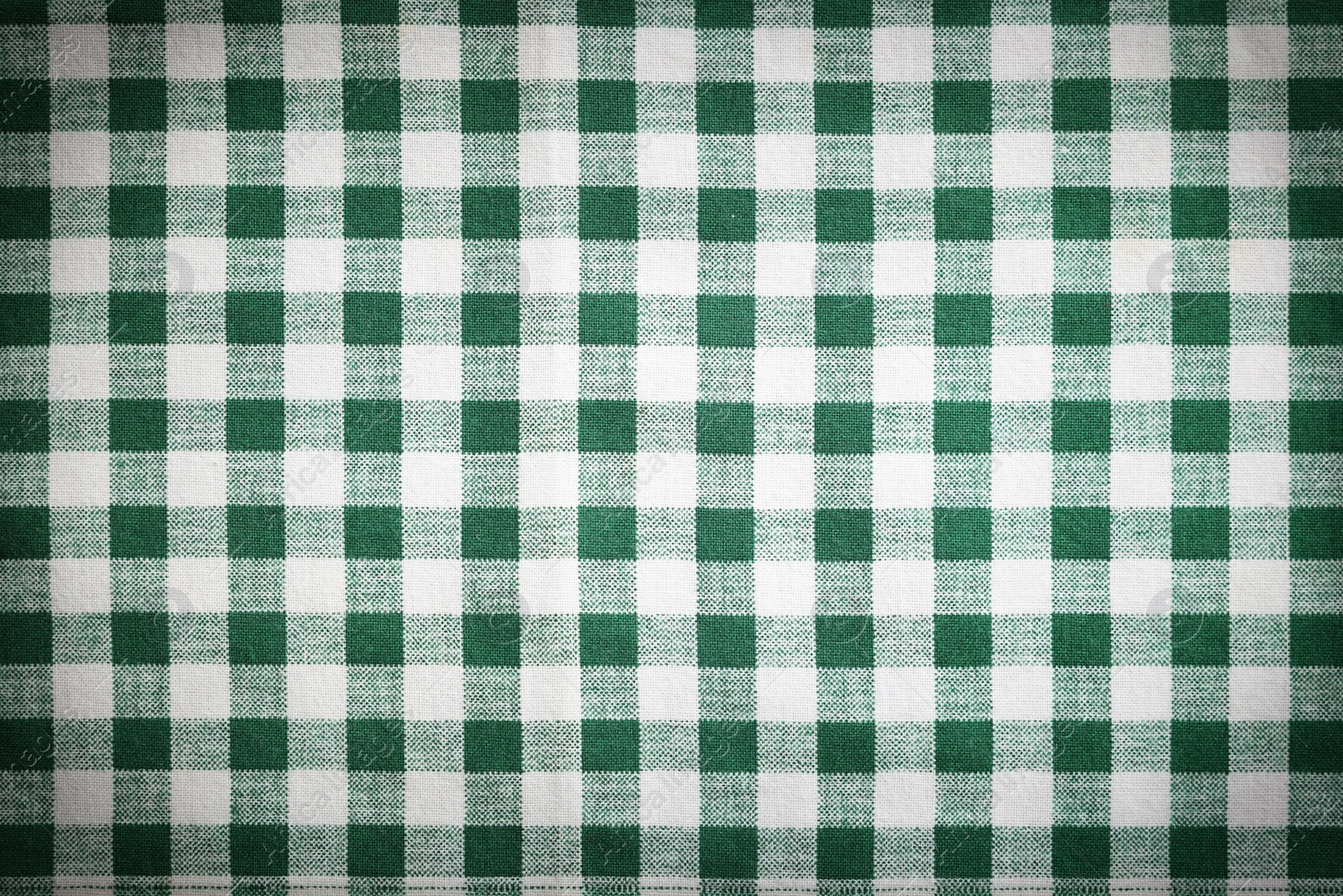 Image of Green and white tablecloth as background, vignette effect