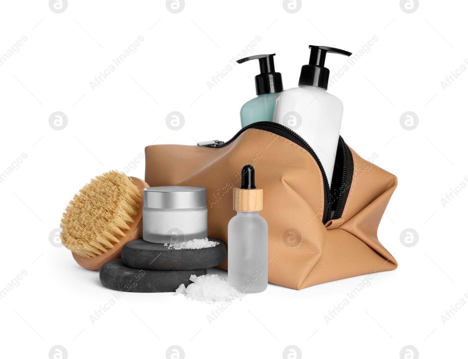 Photo of Compact toiletry bag, spa stones and different cosmetic products isolated on white