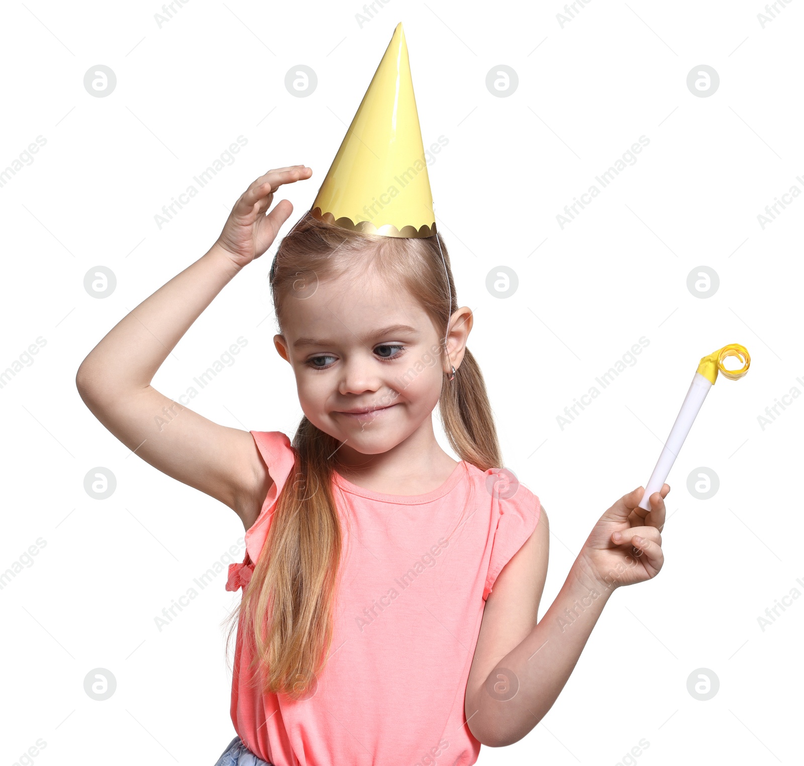 Photo of Birthday celebration. Cute little girl in party hat with blower on white background