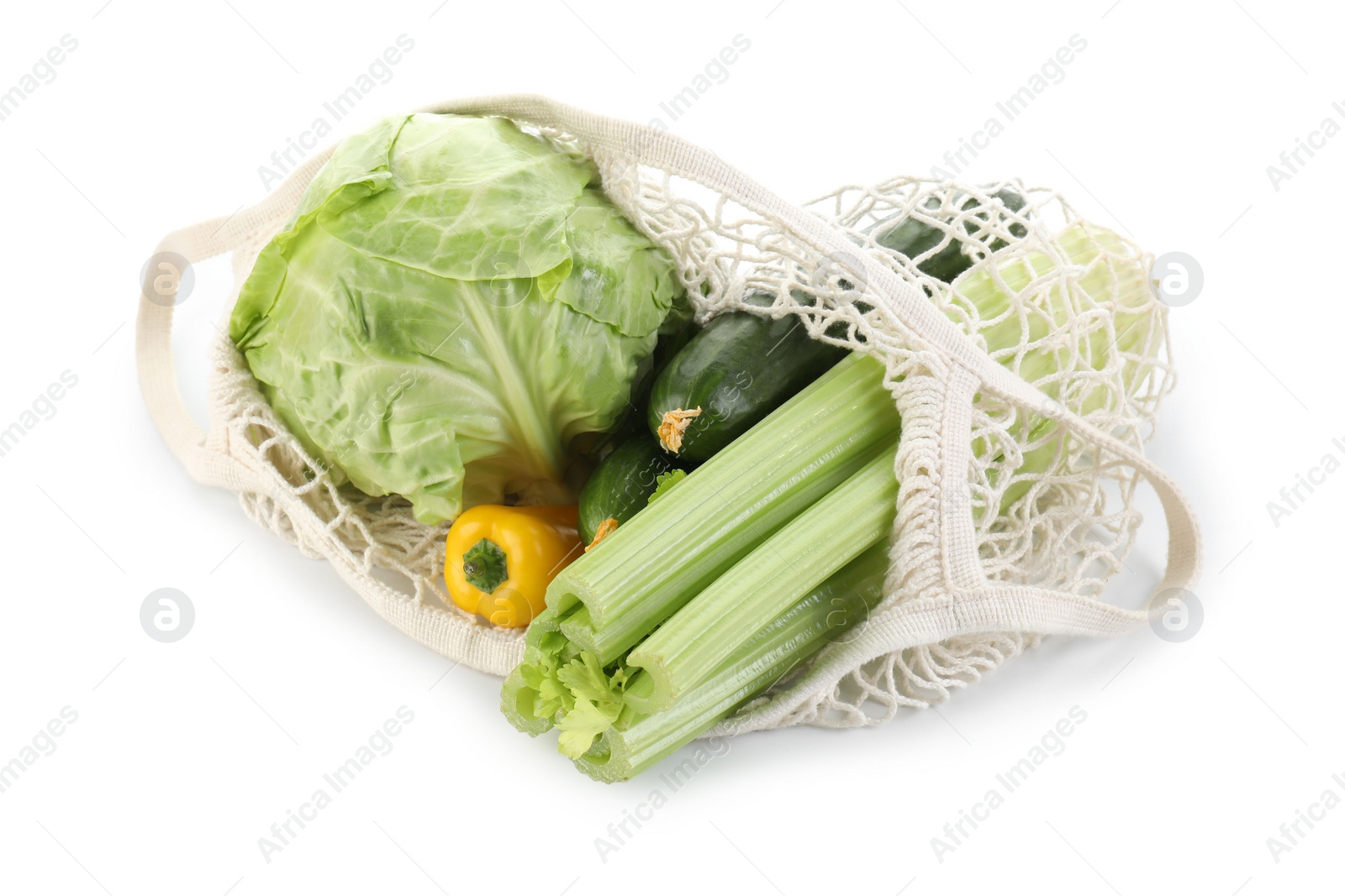 Photo of String bag with different vegetables isolated on white, top view