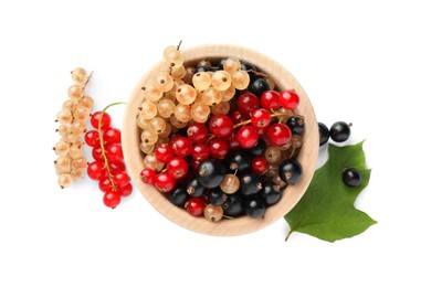 Photo of Fresh red, white and black currants in bowl with green leaf isolated on white, top view