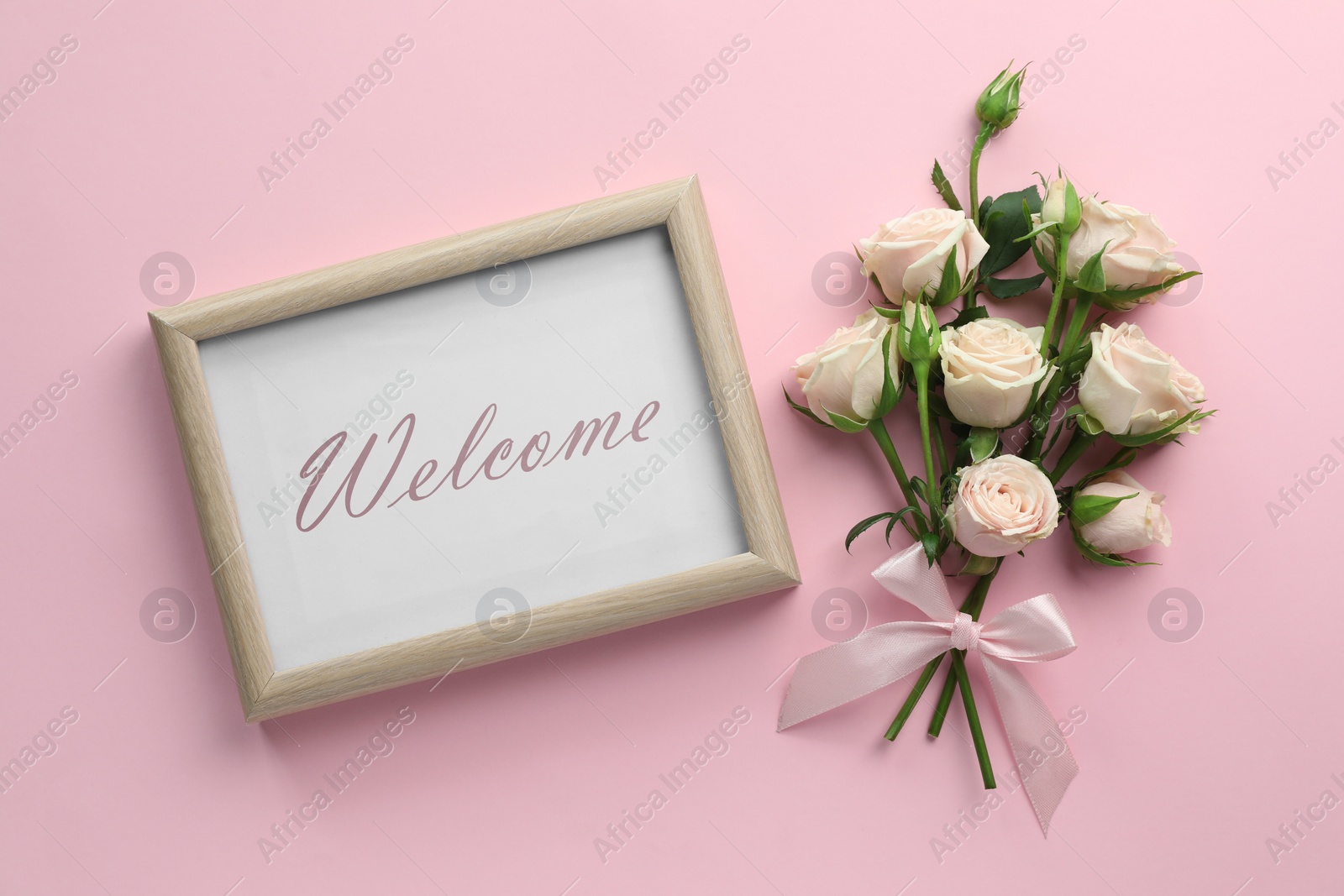 Image of Welcome card. Beautiful roses and frame with word on pink background, flat lay