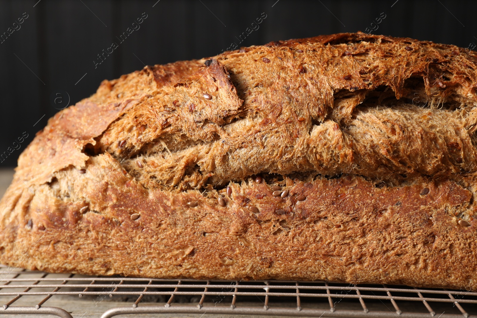 Photo of Freshly baked sourdough bread on wooden table, closeup