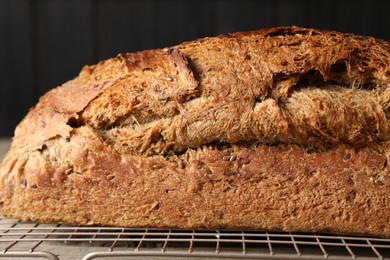 Photo of Freshly baked sourdough bread on wooden table, closeup