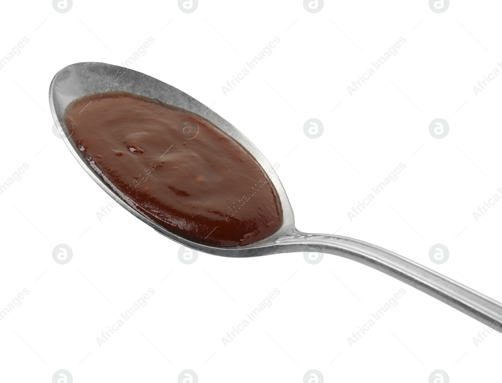 Photo of Tasty barbecue sauce in spoon isolated on white