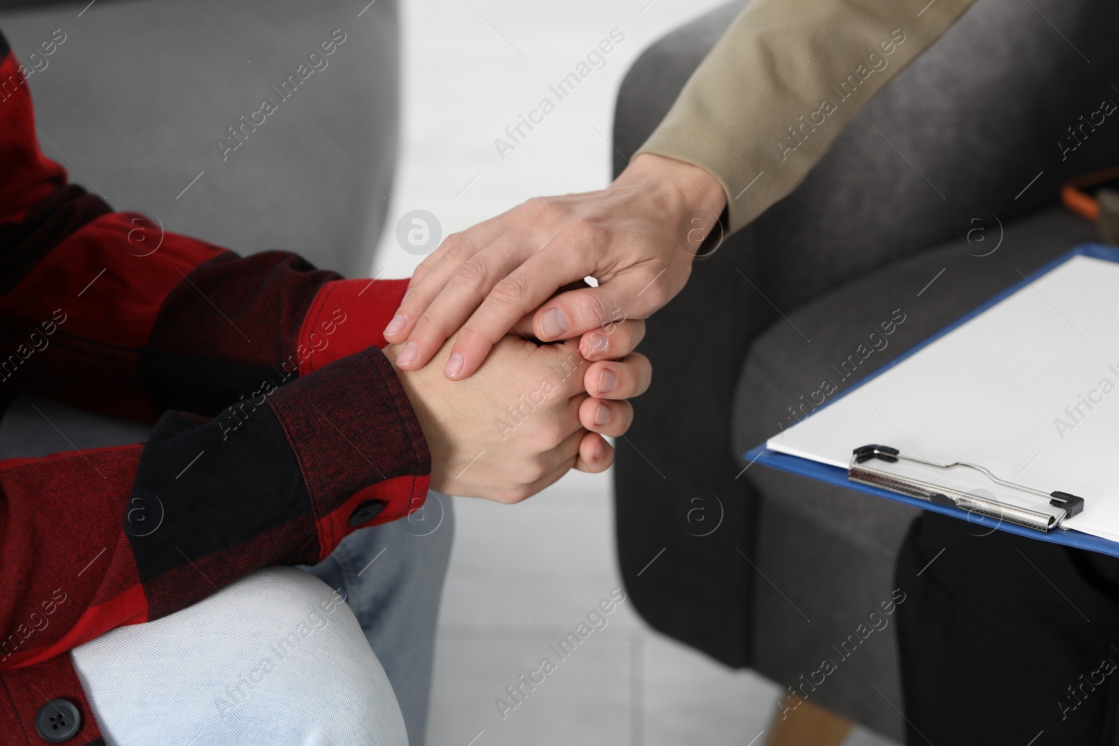 Photo of Psychologist working with teenage boy indoors, closeup. Teenager problems