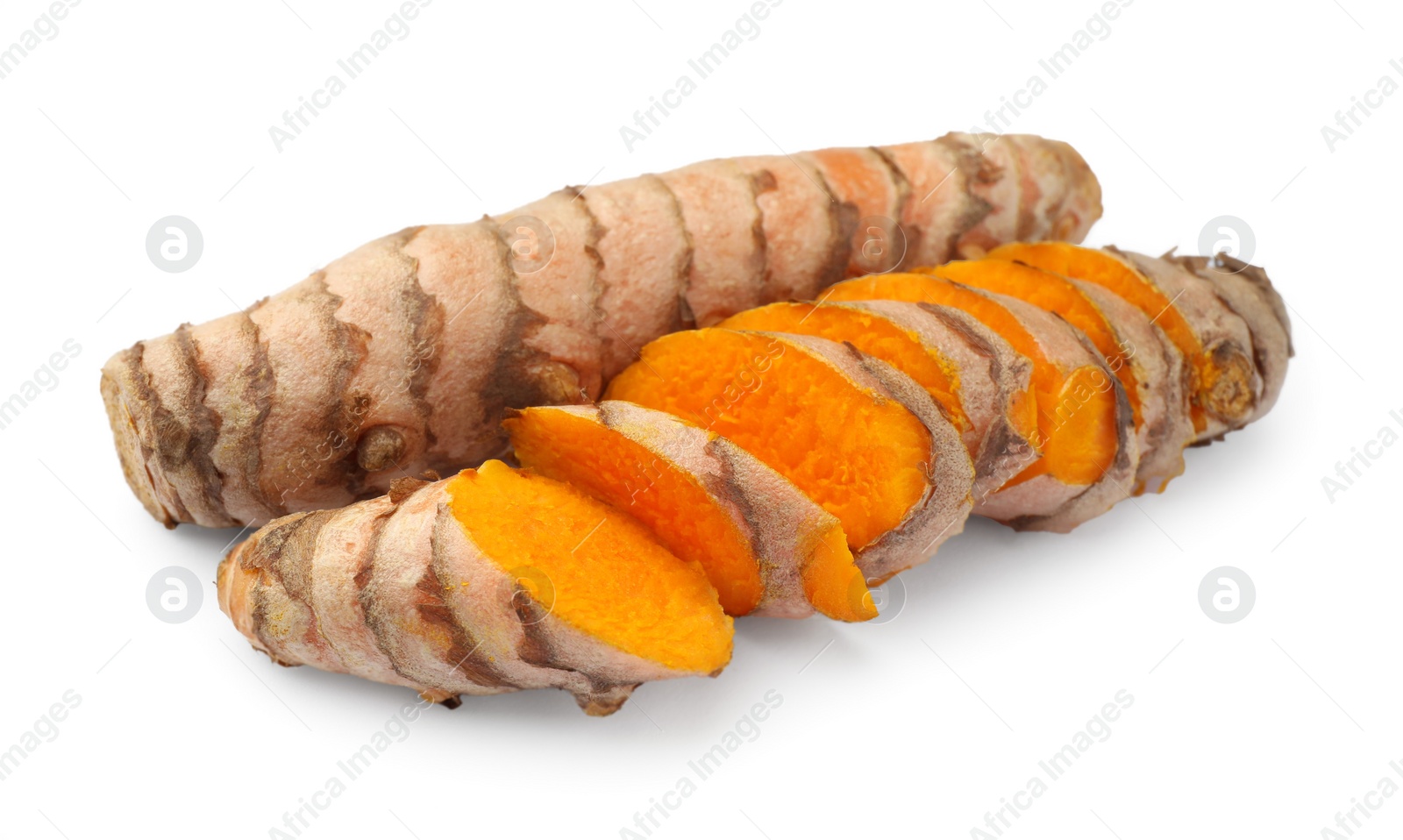 Photo of Whole and cut turmeric roots isolated on white