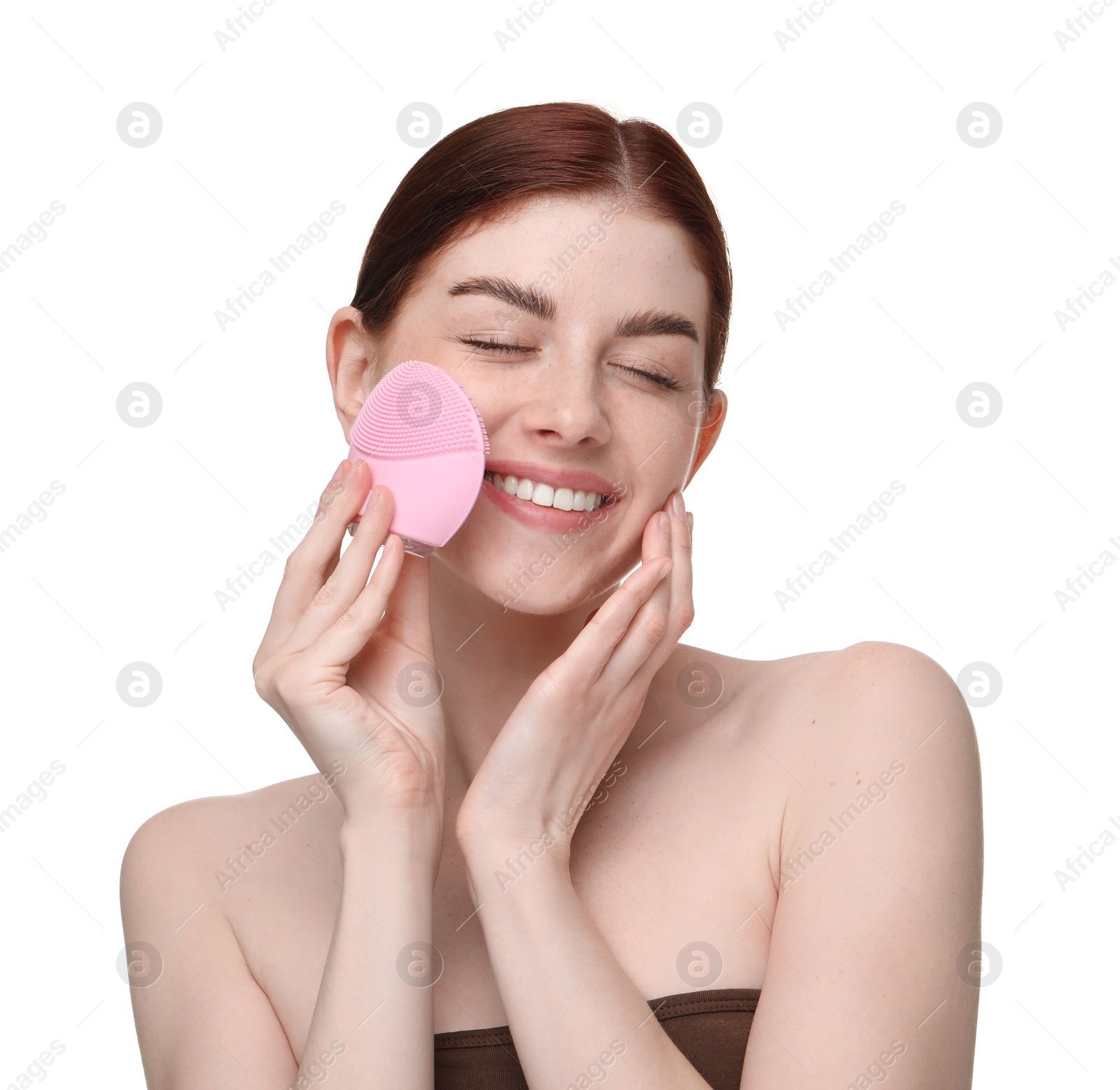 Photo of Washing face. Young woman with cleansing brush on white background