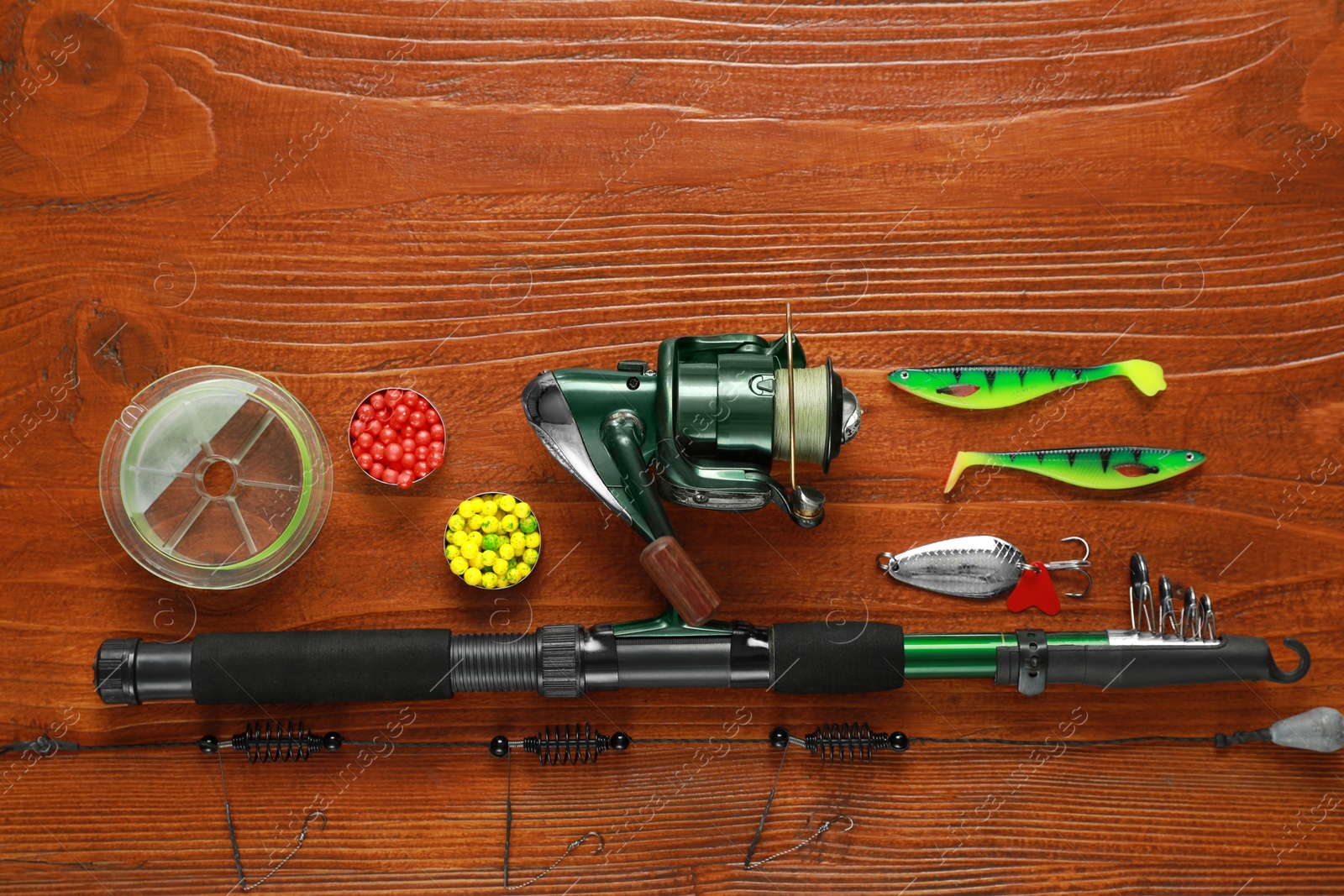 Photo of Fishing tackle on wooden table, flat lay. Space for text