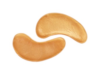 Photo of Golden under eye patches on white background, top view. Cosmetic product