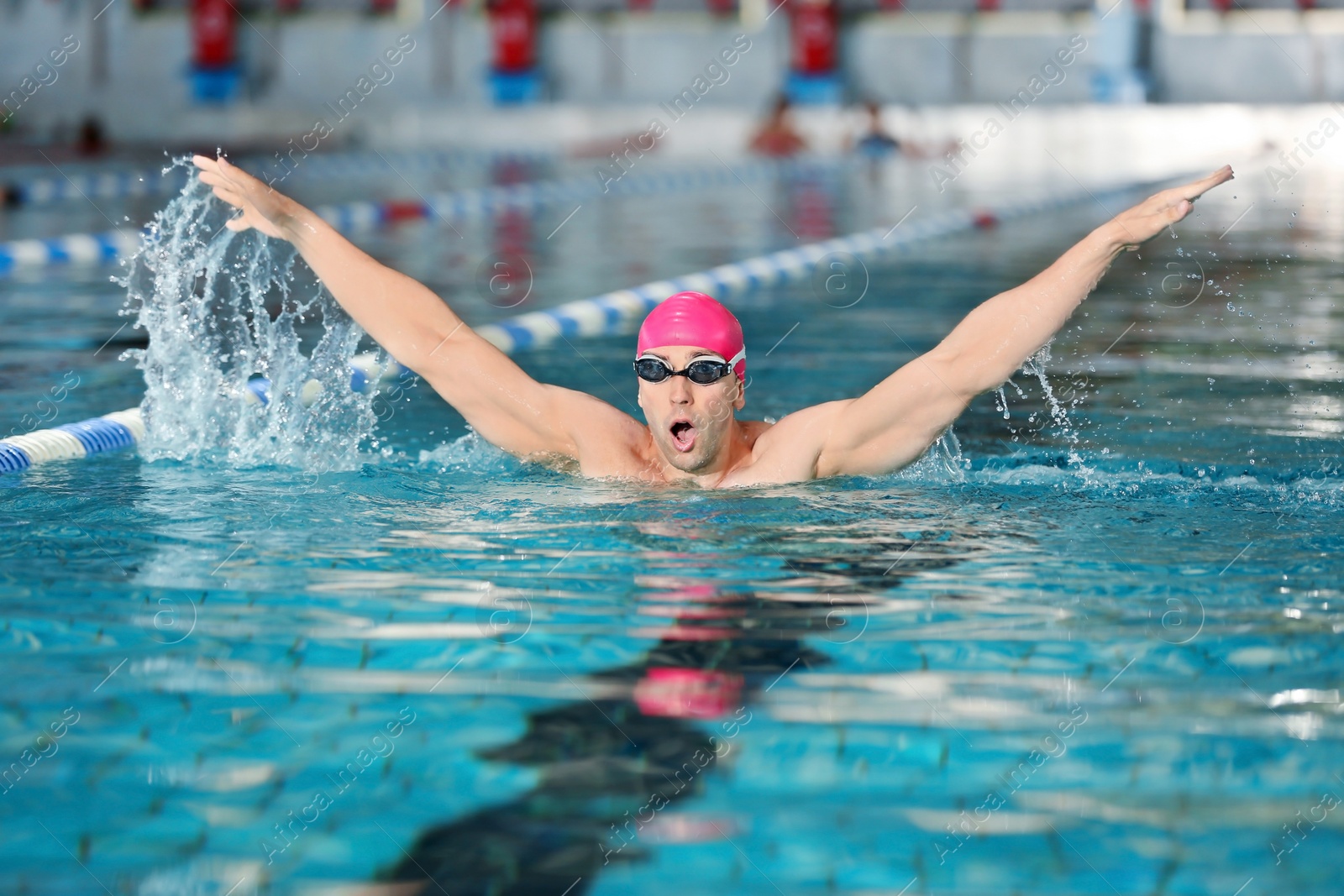 Photo of Young athletic man swimming in pool