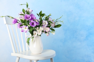 Photo of Vase with bouquet of beautiful flowers on chair against color background. Space for text