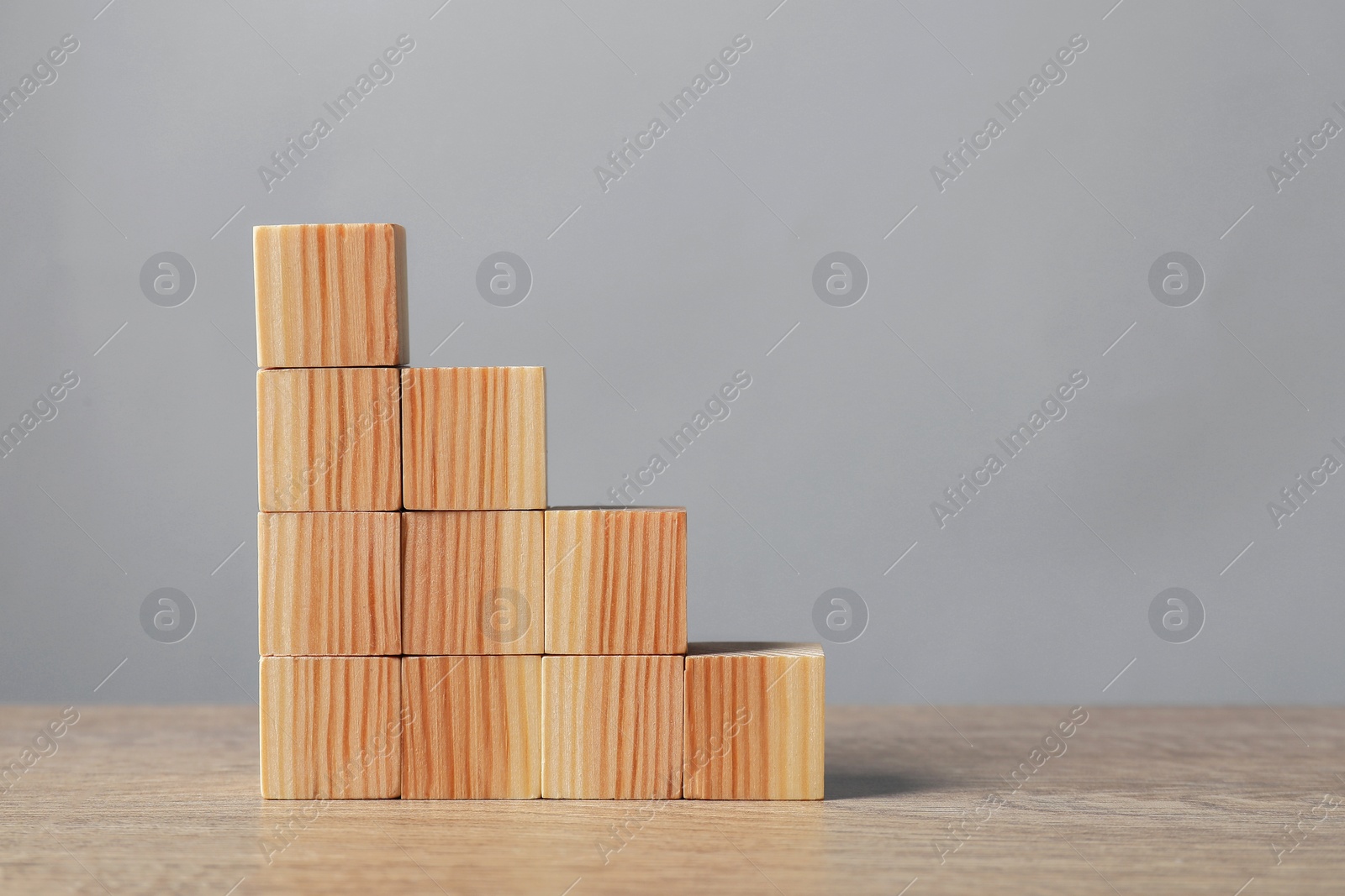 Photo of Blank cubes on wooden table. Space for text